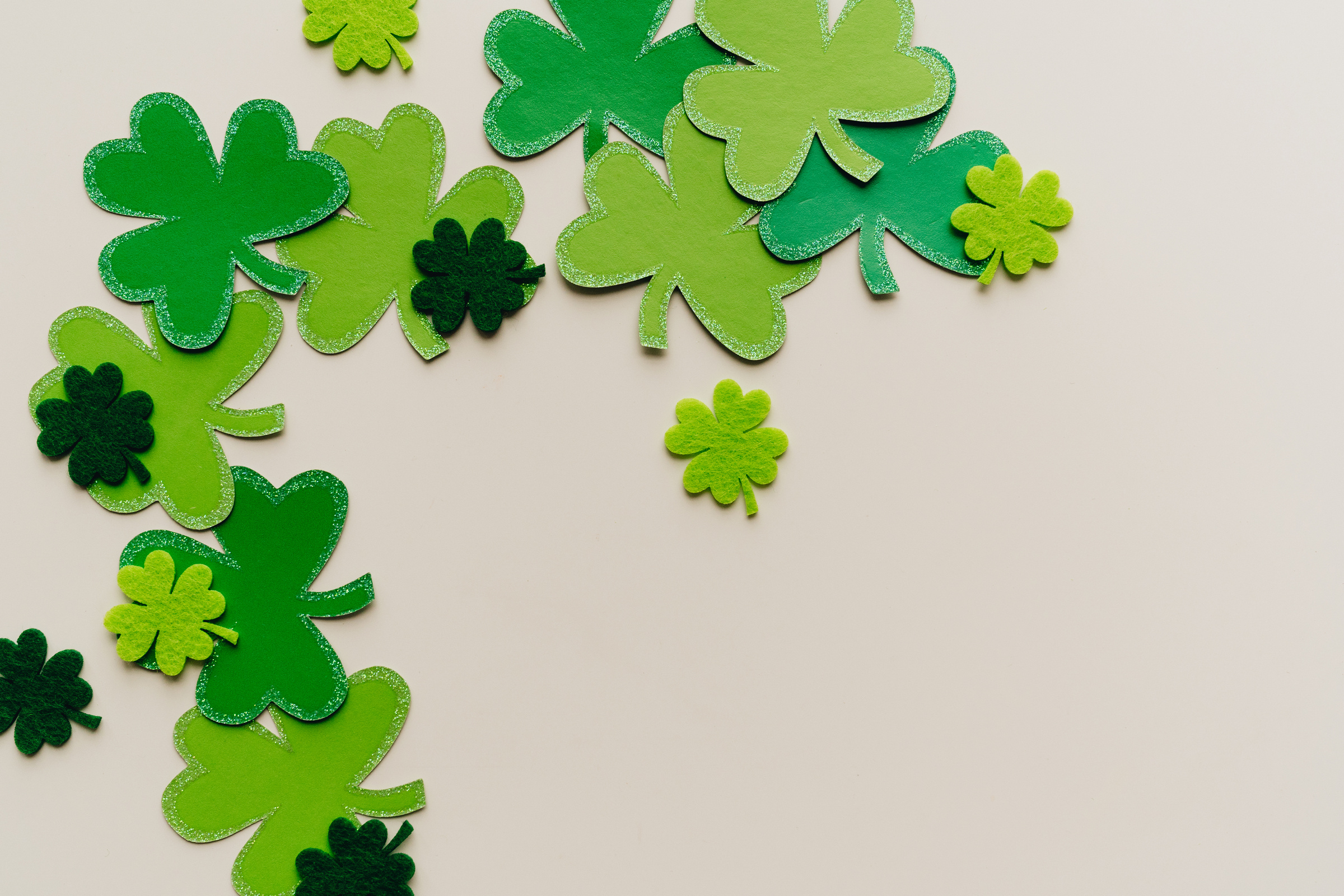 Green Clover Shaped Papers on White Surface